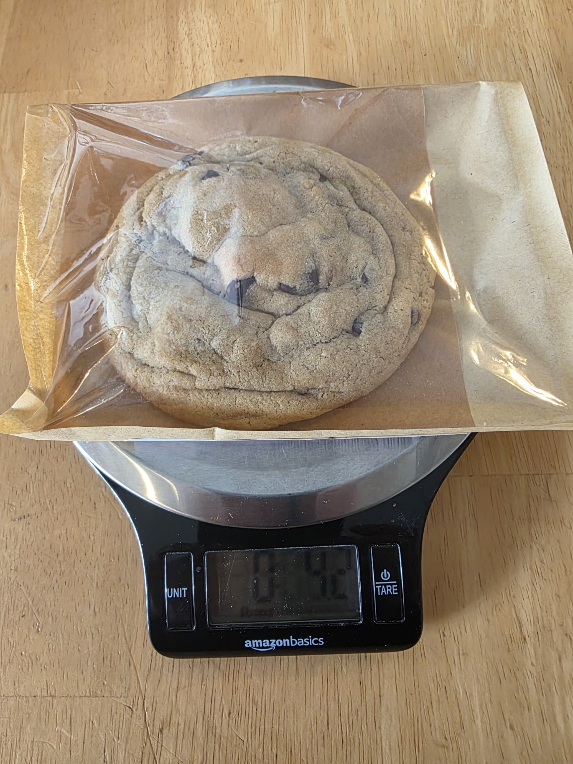 Bad Influence Bakery chocolate chip cookie shown on a scale