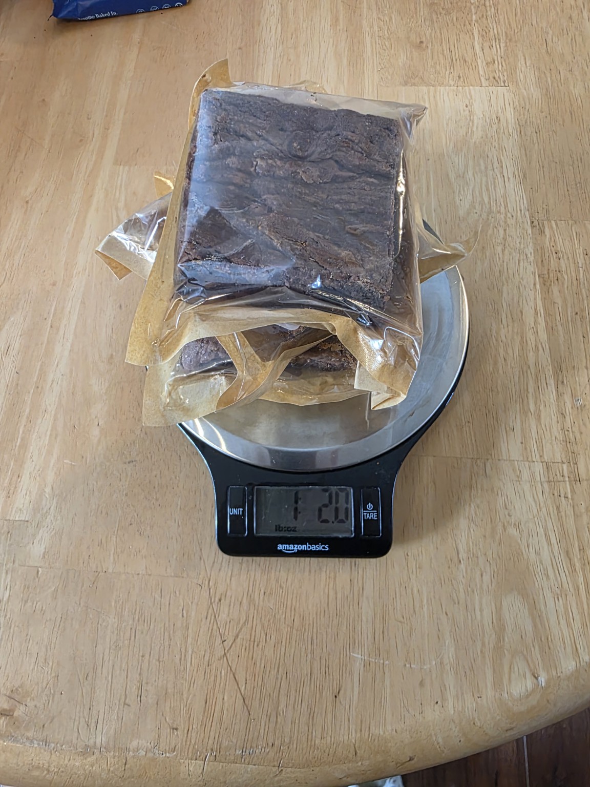 Stack of packaged Bad Influence Bakery Dulce de Leche brownies on a scale