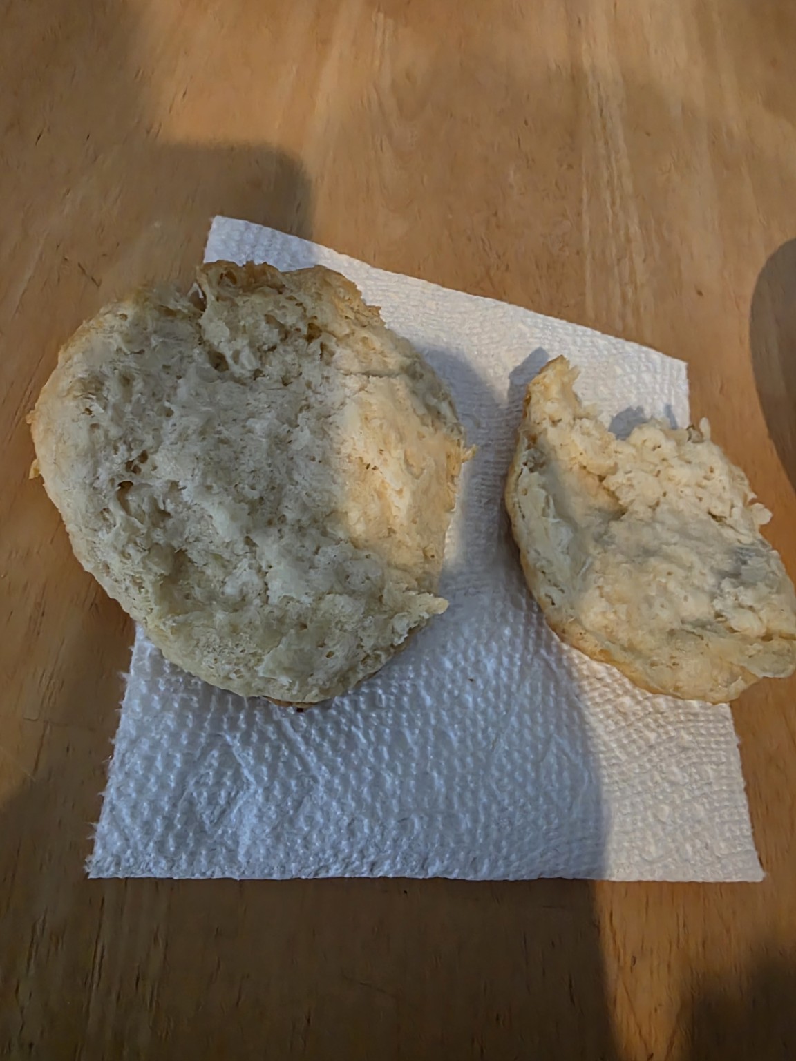 A sourdough biscuit split open to show the tender interior