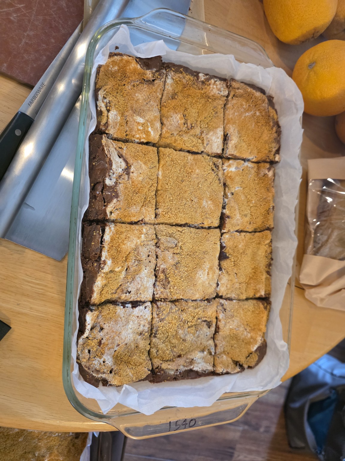Pan of Bad Influence Bakery S’mores brownies with marshmallow and graham topping